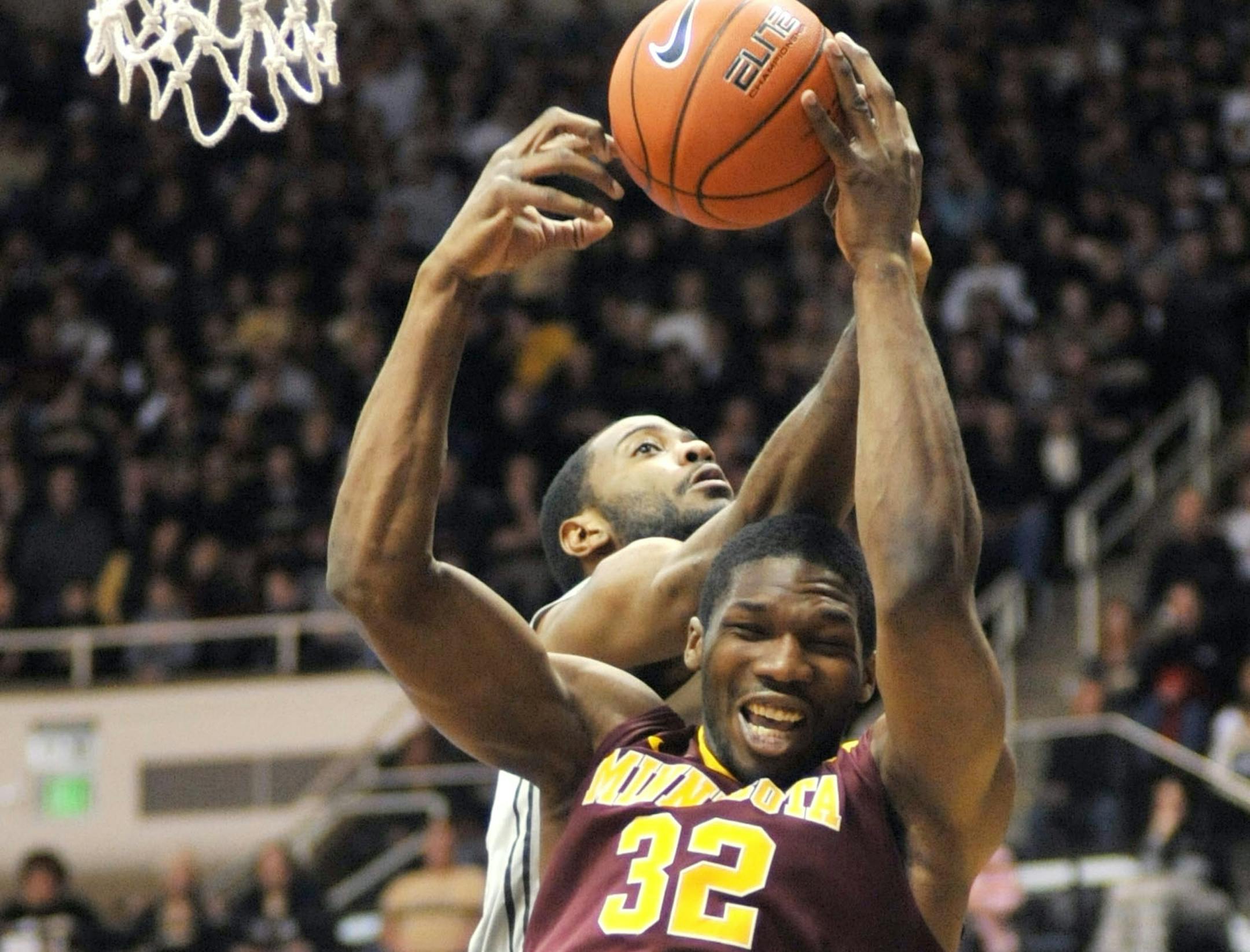 Minnesota's Trevor Mbakwe, front, battles Purdue's Rapheal Davis for a rebound during an NCAA basketball game Saturday, March 9, 2013, in West Lafayette, Ind. Purdue defeated Minnesota 89-73. (AP Photo/Journal & Courier, Alex Farris) NO SALES ORG XMIT: MIN2013030918231035