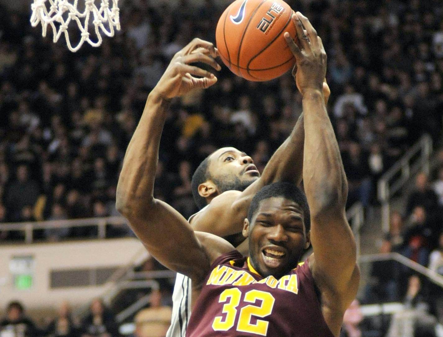 Minnesota's Trevor Mbakwe, front, battles Purdue's Rapheal Davis for a rebound during an NCAA basketball game Saturday, March 9, 2013, in West Lafayette, Ind. Purdue defeated Minnesota 89-73. (AP Photo/Journal & Courier, Alex Farris) NO SALES ORG XMIT: MIN2013030918231035