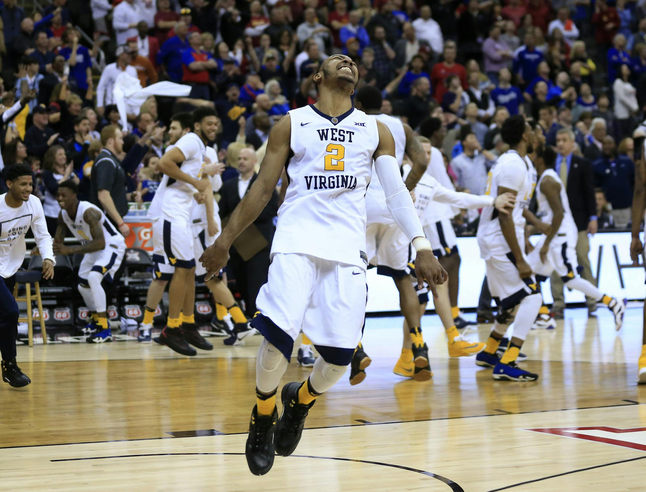 West Virginia guard Jevon Carter (2) celebrates after the team's NCAA college basketball game against Oklahoma in the semifinals of the Big 12 conference men's tournament in Kansas City, Mo., Friday, March 11, 2016. West Virginia defeated Oklahoma 69-67. (AP Photo/Orlin Wagner)