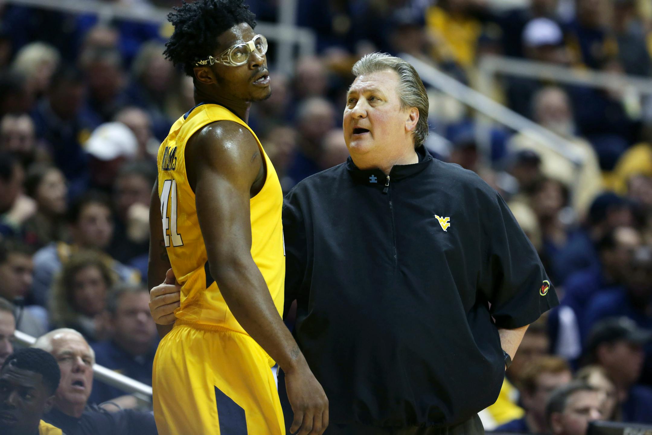West Virginia head coach Bob Huggins talks to forward Devin Williams (41) during the first half of an NCAA college basketball game against Baylor, Saturday, Feb, 6, 2016, in Morgantown, W.Va. (AP Photo/Raymond Thompson)