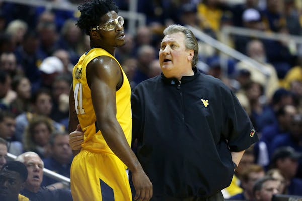 West Virginia head coach Bob Huggins talks to forward Devin Williams (41) during the first half of an NCAA college basketball game against Baylor, Sat