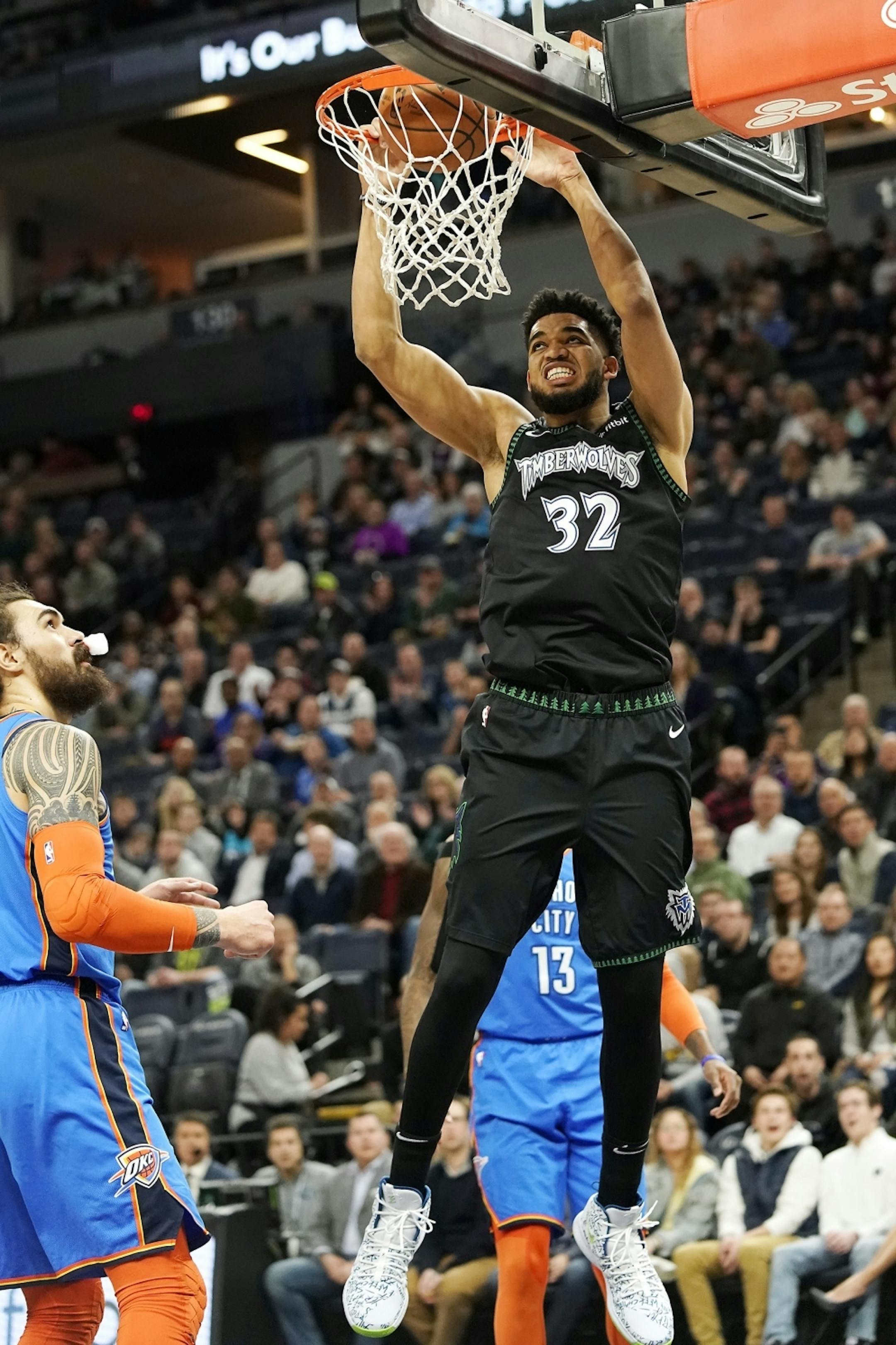 Minnesota Timberwolves center Karl-Anthony Towns (32) dunks the ball during the first half.