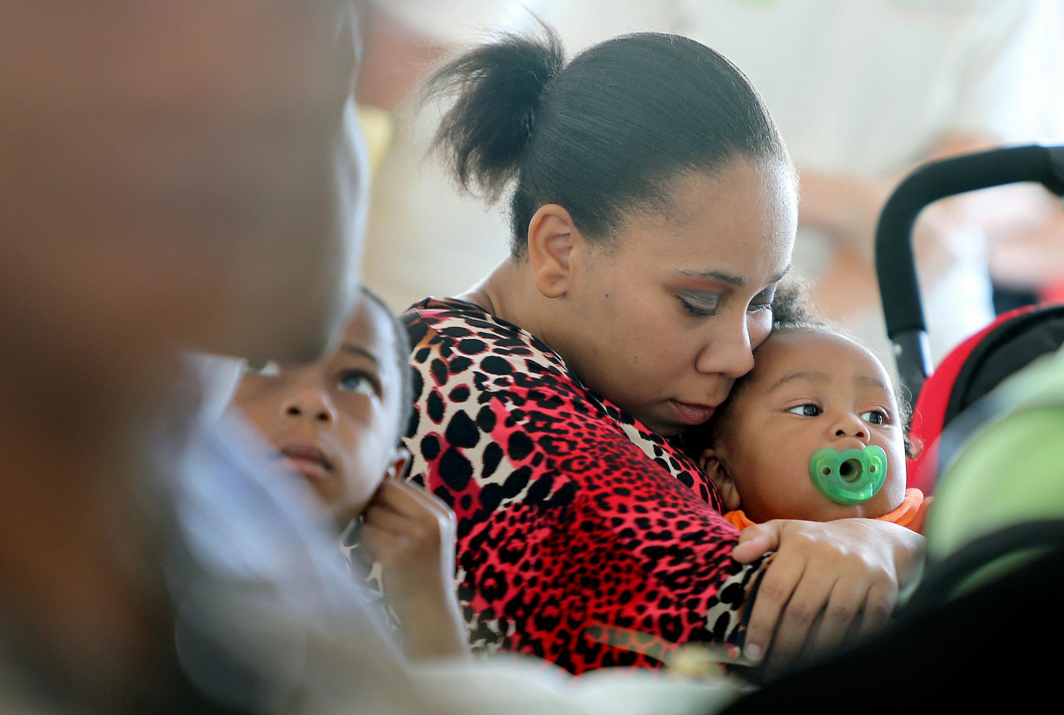Tiffany Parr hugged her son Lucius McCoy Jr., during the groundbreaking ceremony of a new $24.5 million Washburn Center for Children, Tuesday.