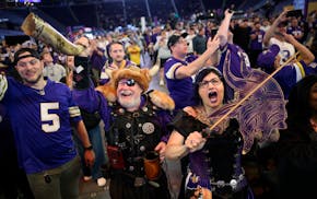 Greg “Sir Odin” Hanson, of Watkins, and Cheryl “Lady Dakota” Pendleton, of Shakopee, cheer after the Vikings picked Ohio State guard Donovan J