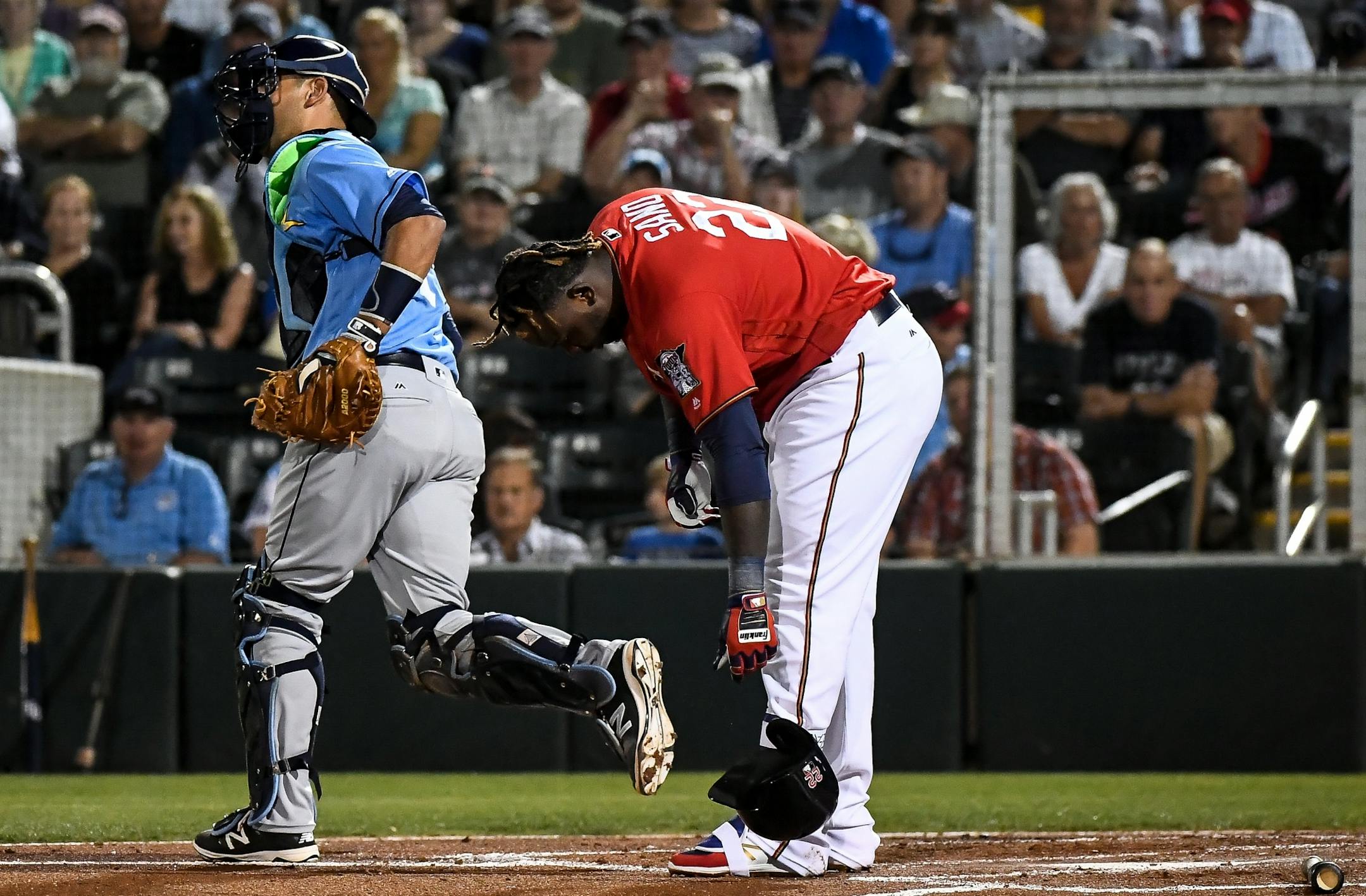 Minnesota Twins third baseman Miguel Sano (22) dropped his helmet and took off his shin guard after being struck out swinging in bottom of the first sinning Friday night.