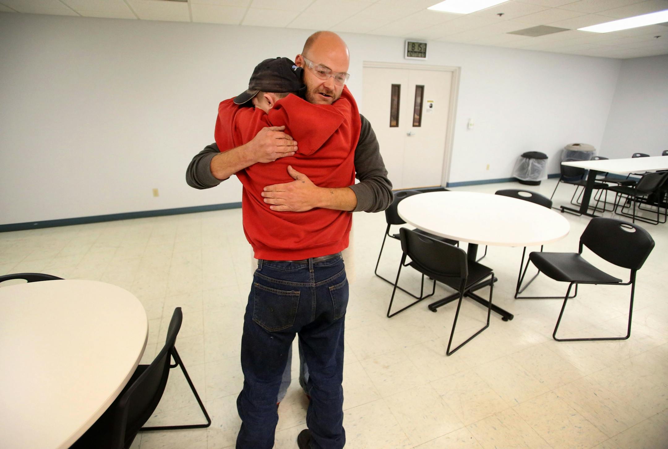 Disabled workers like John Week, 37, have opportunities that they never thought possible. Workers who once toiled for years in dead-end jobs are now making up to $14 an hour at an MDI facility and have opportunities for advancement. Here, Week, greets worker Ben Sanborn, one of the first to arrive, with a hug Tuesday, Sept. 27, 2016, in Cohasset, MN.