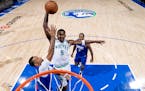 Anthony Edwards (5) of the Minnesota Timberwolves is fouled by Norman Powell (24) of the LA Clippers while attempting a dunk in the first half Sunday,