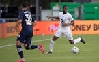 Minnesota United midfielder Kevin Molino (7) sets up a play in front of Sporting Kansas City defender Luis Martins (36) during the first half of an ML