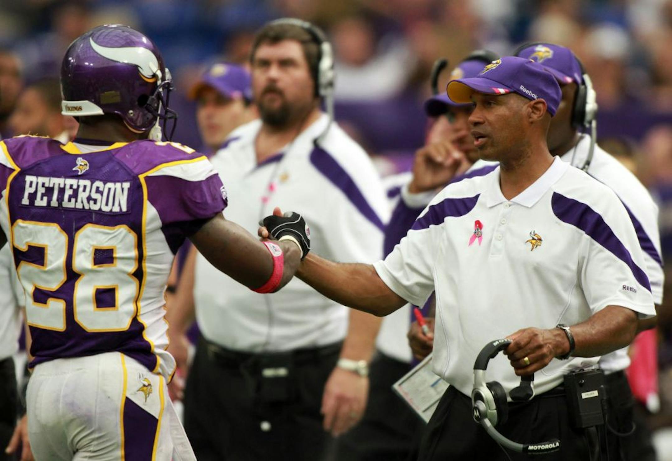 Head coach Leslie Frazier congratulated running back Adrian Peterson after the Vikings ran the ball for several first downs late in the fourth quarter at Mall of America Field in Minneapolis, MN, on October 9, 2011. The Minnesota Vikings defeated the Arizona Cardinals 34-10.