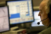 A 911 operator answers emergency calls at a Minneapolis dispatch center.