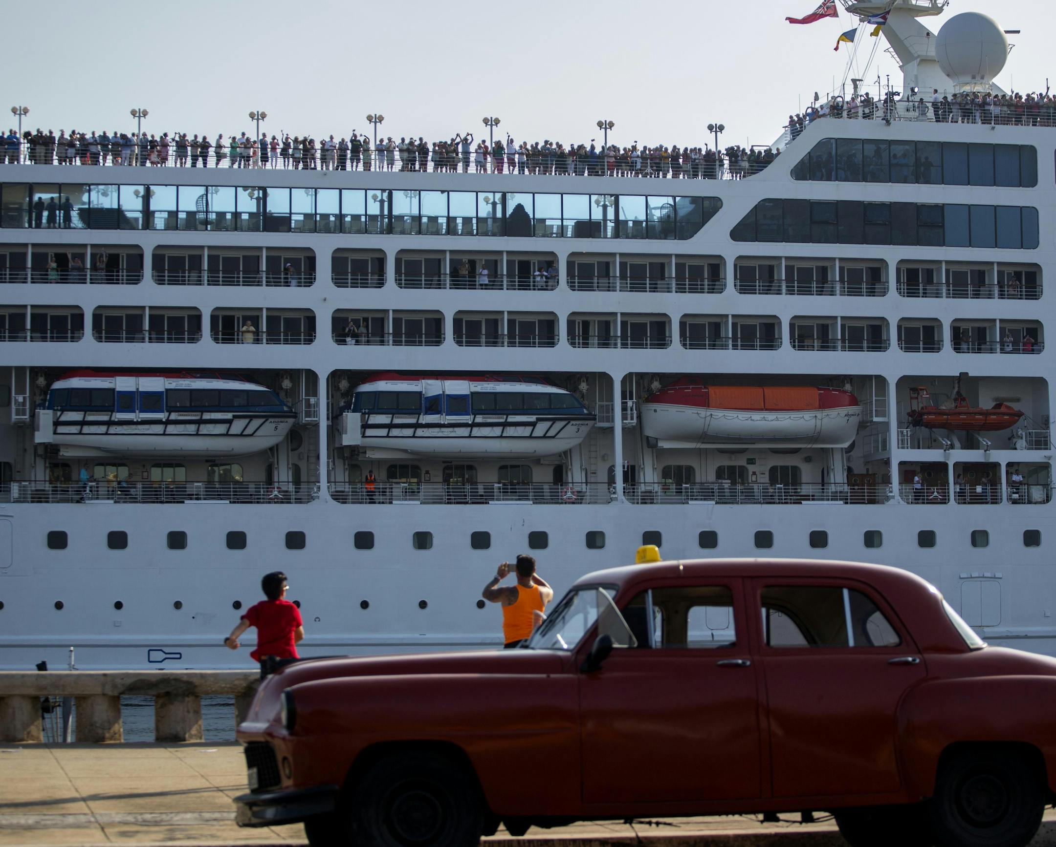 FILE - This May 2, 2016, file photo, shows the Adonia cruise ship arriving in Havana, Cuba, from Miami. The Adonia, operated by Carnival Corporation's Fathom brand, is scheduled to continue cruises to Cuba every other week through the last week in May. Havana is also on the itinerary for sailings from Florida in April and May aboard Royal Caribbean's Empress of the Seas ship and in May on Norwegian Cruise Line's Norwegian Sky. Long-term prospects for cruises and other forms of travel from the U.