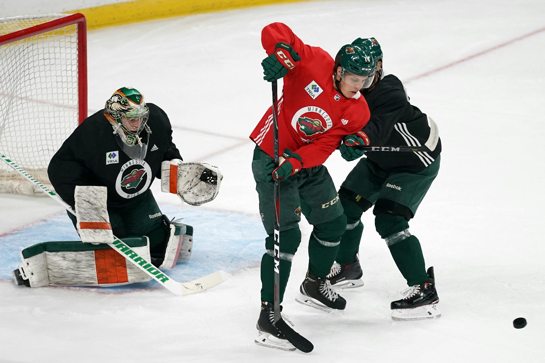 Minnesota Wild center Joel Eriksson Ek (14) tried to defect the puck in.
