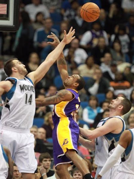 Wolves center Nikola Pekovic, left, blocked a shot by Shannon Brown in the second quarter Tuesday. It was a frustrating night for Minnesota big men as