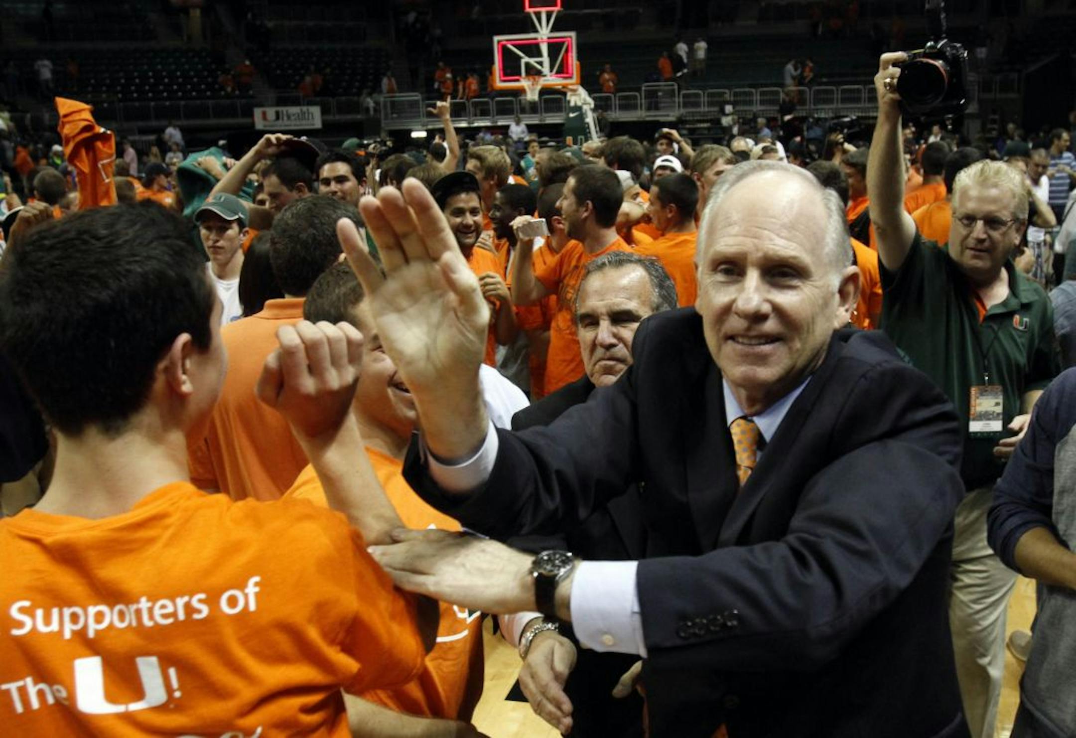 Miami's head coach Jim Larranaga is congratulated by fans after a 67-59 win over Michigan State