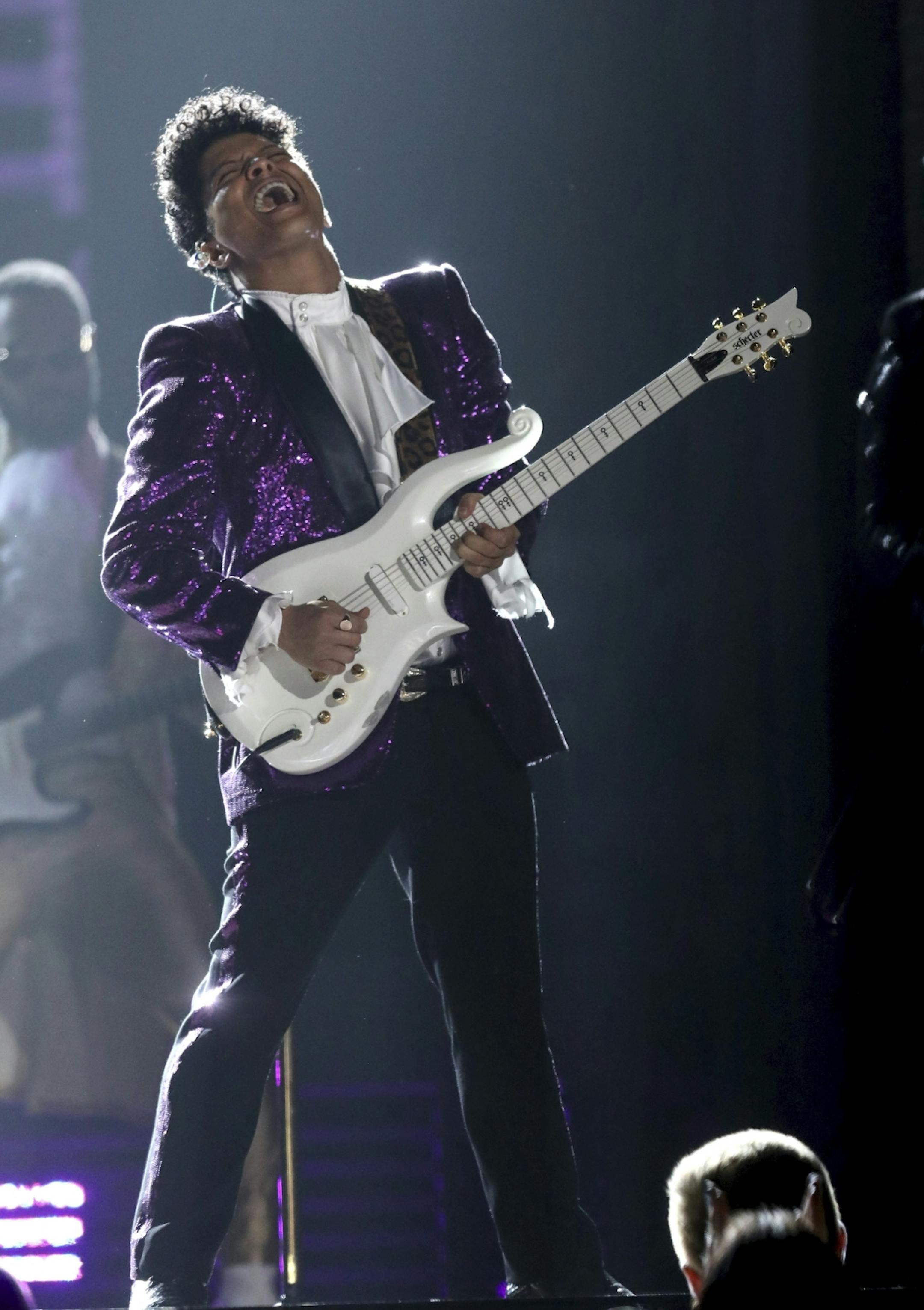 Bruno Mars performs "Let's Go Crazy" during a tribute to Prince at the 59th annual Grammy Awards.
