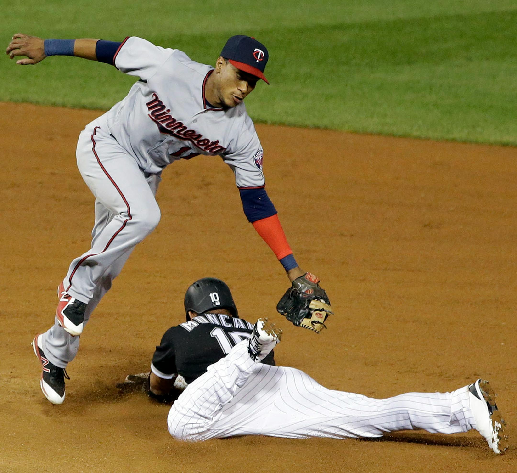Chicago White Sox's Yoan Moncada, right, steals second base as Minnesota Twins shortstop Jorge Polanco applies a taste tag during the fourth inning of a baseball game Thursday, Aug. 24, 2017, in Chicago.