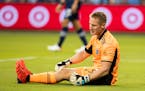 Sporting Kansas City goalkeeper Tim Melia reacts after conceding a goal during the first half of an MLS soccer match against the Seattle Sounders, Sun