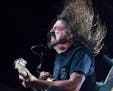 Dave Grohl gives an energetic performance with the Foo Fighters at Xcel Energy Center in St. Paul August 22, 2015.