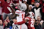 Ohio State’s Marvin Harrison Jr. (18) made a catch, fending off coverage from Wisconsin’s Jason Maitre (23) when the teams met Oct. 28 in Madison.