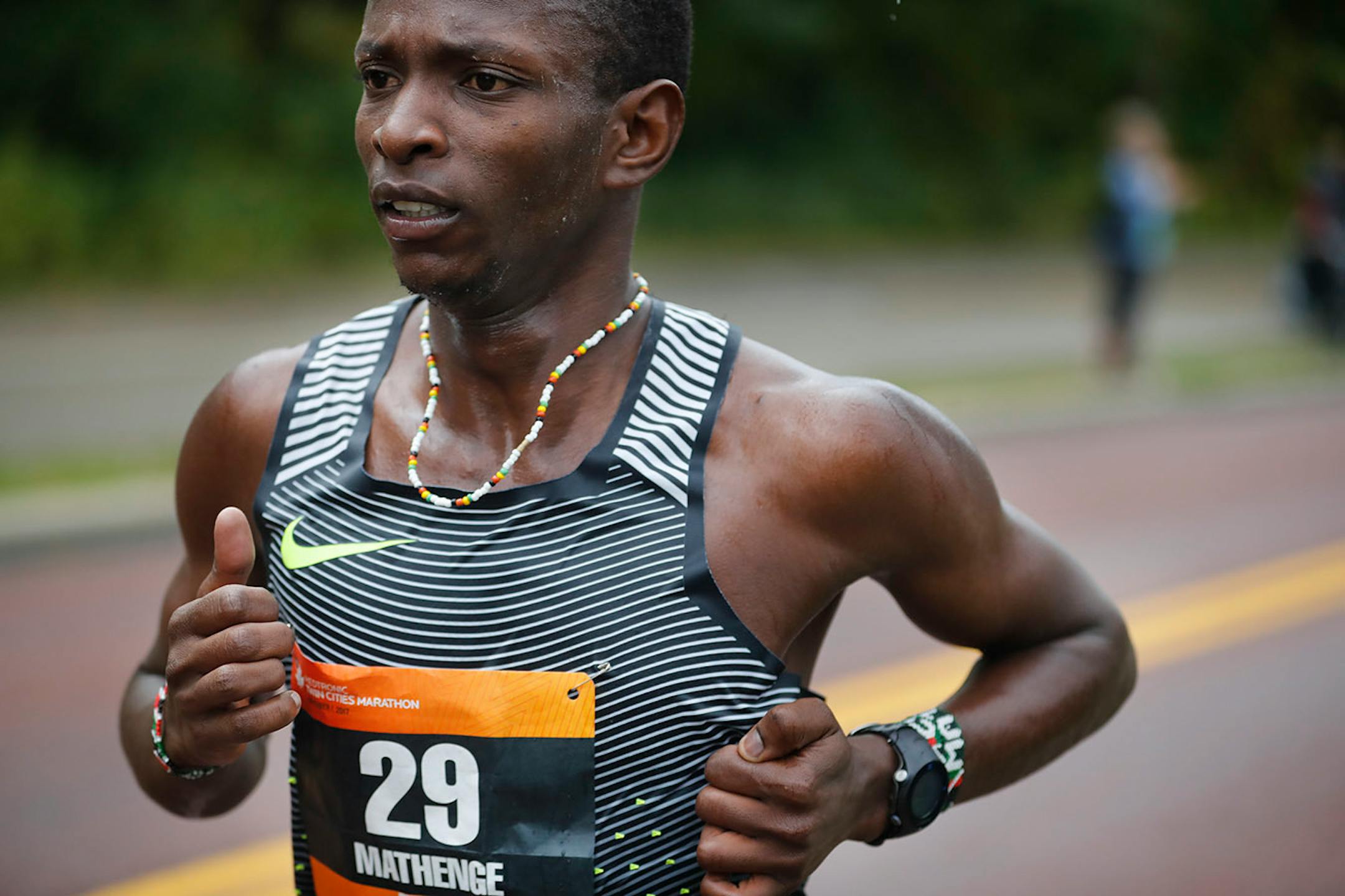 Runner Charles Mathenge(29) goes by the 17-mile marker.
