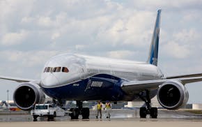 FILE - In this March 31, 2017, file photo, Boeing employees walk the new Boeing 787-10 Dreamliner toward the delivery ramp area at the company's facil