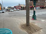 A wooden pole sits in the middle of the sidewalk at the intersection of Lake and Lyndale. Pedestrians will be sidestepping dozens of the temporary pos
