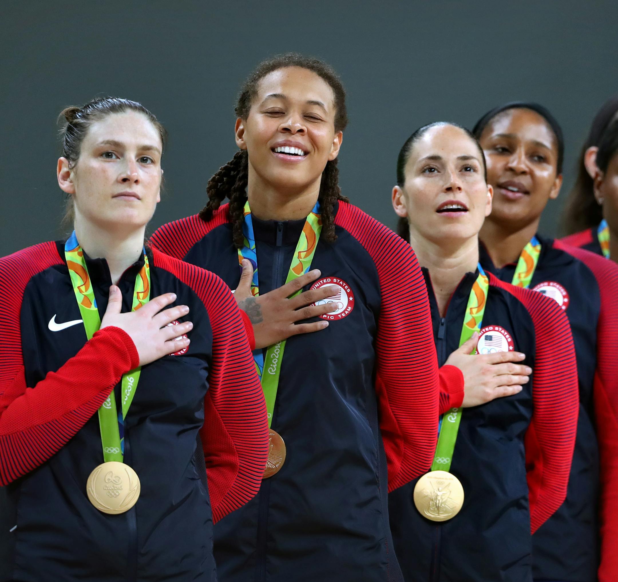 The USA women&#xed;s Olympic basketball team savors the moment during the national anthem after their 6th consecutive gold medal win. Here, Lynx players Lindsay Whalen and Seimone Augustus (left) Sue Bird, Maya Moore also with the Lynx, and Angel McCoughtry. The Lynx's Lindsay Whalen scored 17 points off the bench in the victory, giving the U.S. women's basketball team its sixth consecutive gold medal. ] 2016 Summer Olympic Games - Rio Brazil brian.peterson@startribune.com Rio de Janeiro, Brazil