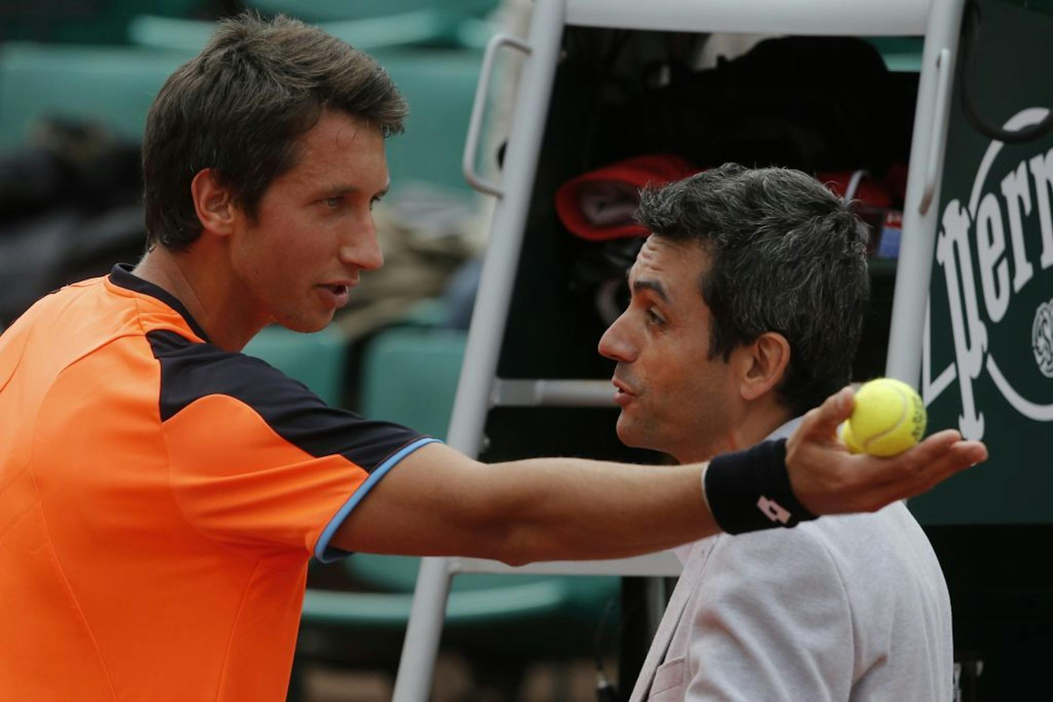 Ukraine's Sergiy Stakhovsky, left, argues the decision of the umpire to call the ball in, in his first round match against Richard Gasquet of France at the French Open tennis tournament, in Roland Garros stadium in Paris, Monday, May 27, 2013. Stakhovsky later took a picture with his smart phone of the mark of the ball on the clay court.