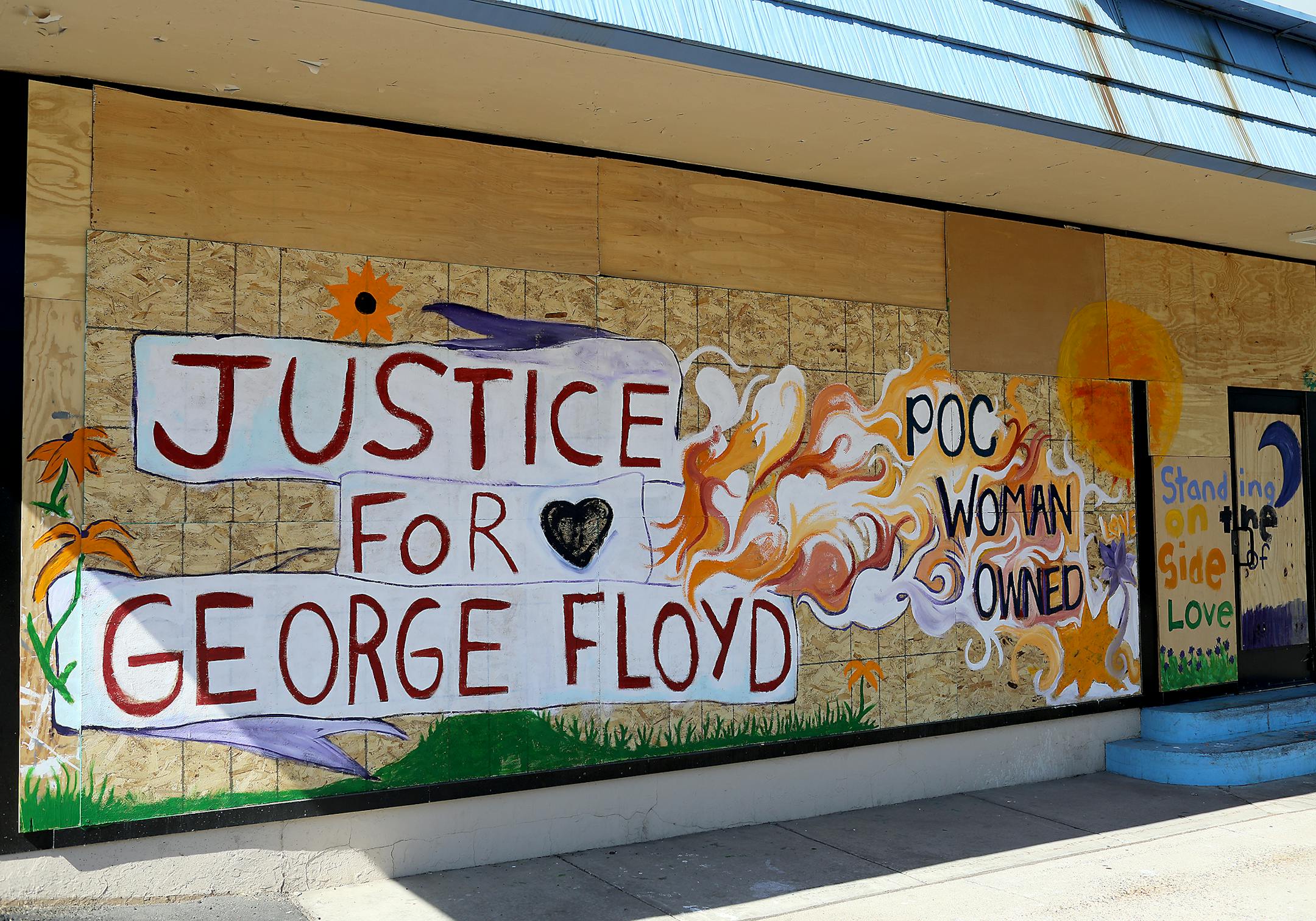 Flowers pop up around the George Floyd solidarity mural at Ananya Dance Theatre at 1197 University Ave. W. in St. Paul.