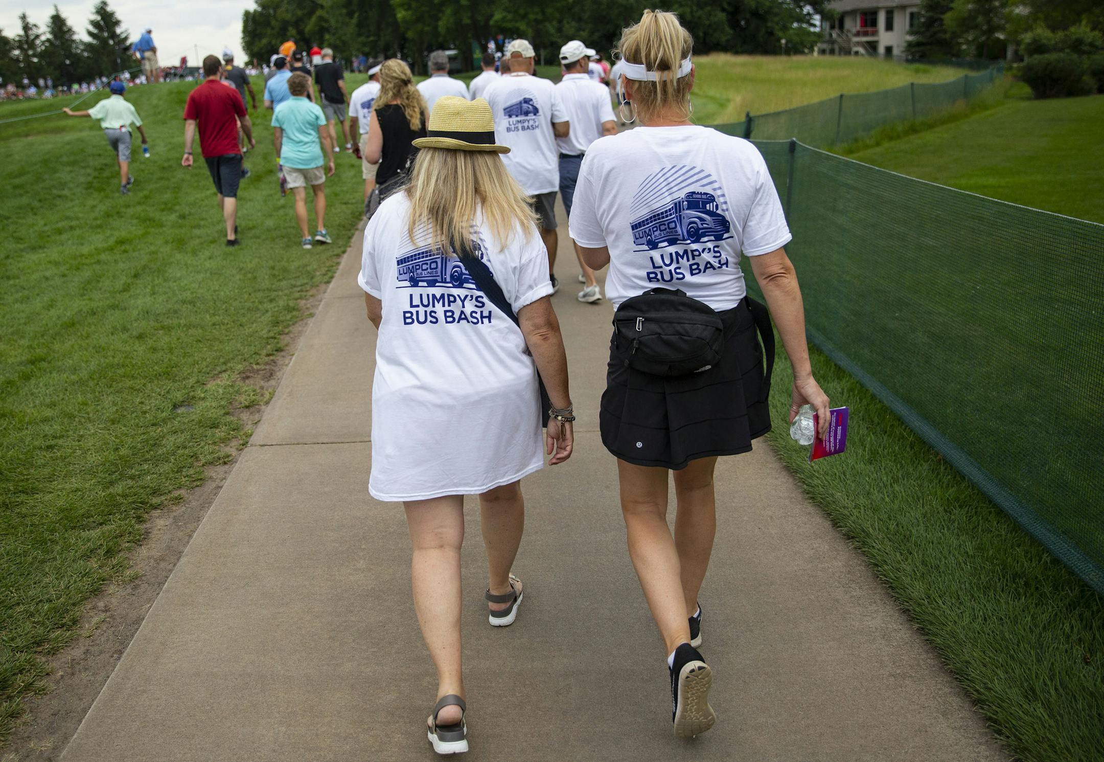 A pair of Tim Herron fans walk alongside the seventh fairway while weRINF "Lumpy's Bus Bash" shirts. ALEX KORMANN &#xa5; alex.kormann@startribune.com Competitors for the 3M Open took to the course on Friday for the second day of the PGA tour event. Notable players include Phil Mickelson, Brooks Koepka, Patrick Reed and Bryson DeChambeau.