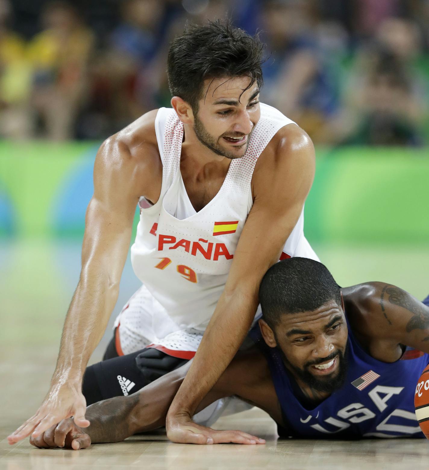 Spain's Ricky Rubio, left, fights for a loose ball with United States' Kyrie Irving, right, during a semifinal round basketball game at the 2016 Summer Olympics in Rio de Janeiro, Brazil, Friday, Aug. 19, 2016. (AP Photo/Charlie Neibergall)