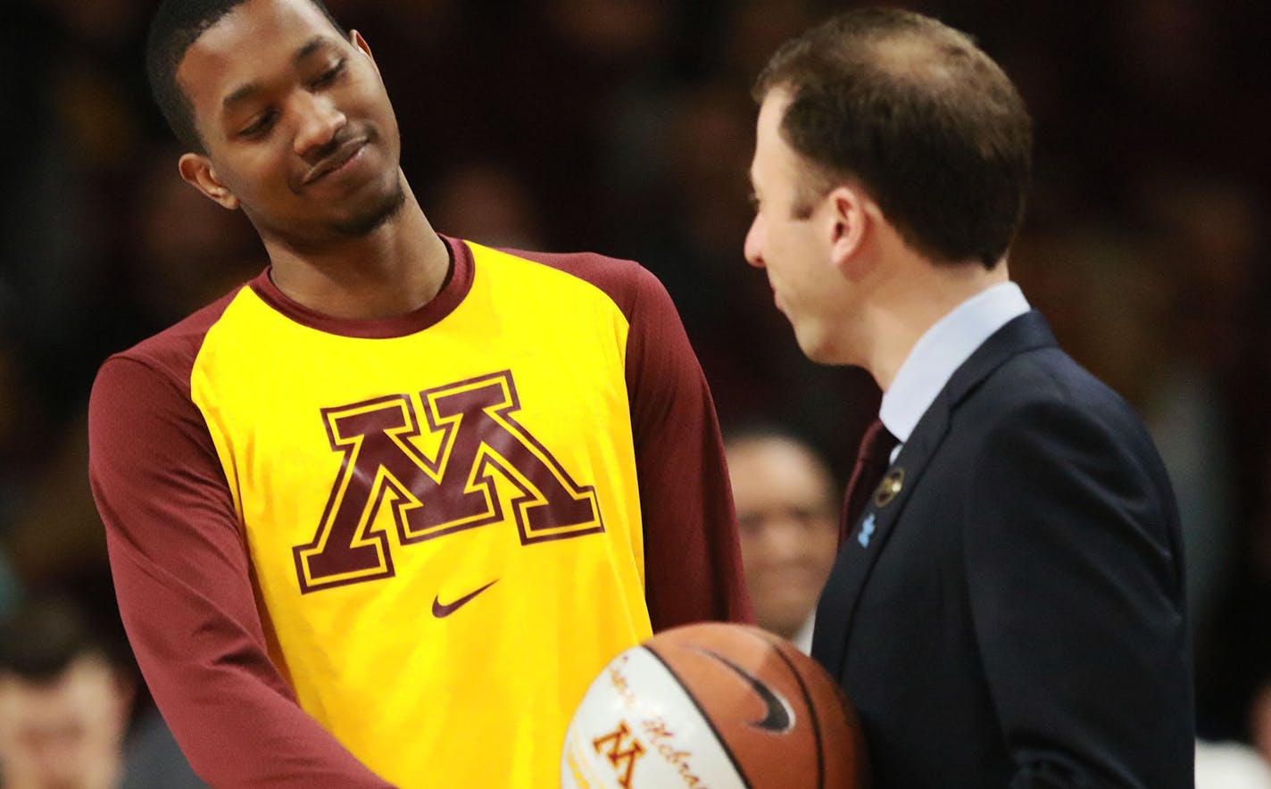 The University of Minnesota's Dupree McBrayer gets a ball and a handshake from head coach Richard Pitino for having scored a thousand points during his career prior to the Gophers game with Indiana Saturday, Feb. 16, 2019, at Willams Arena in Minneapolis, MN. Minnesota beat Indiana 84-63.] DAVID JOLES &#x2022;david.joles@startribune.com Gophers vs. Indiana men's basketball