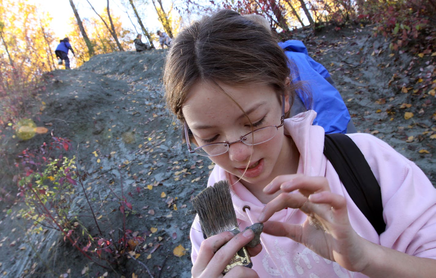 St. Paul Expo Elementary School student Charlotte Richardson-Deppe and fellow fifth- and sixth-grade students used brushes to check their finds.