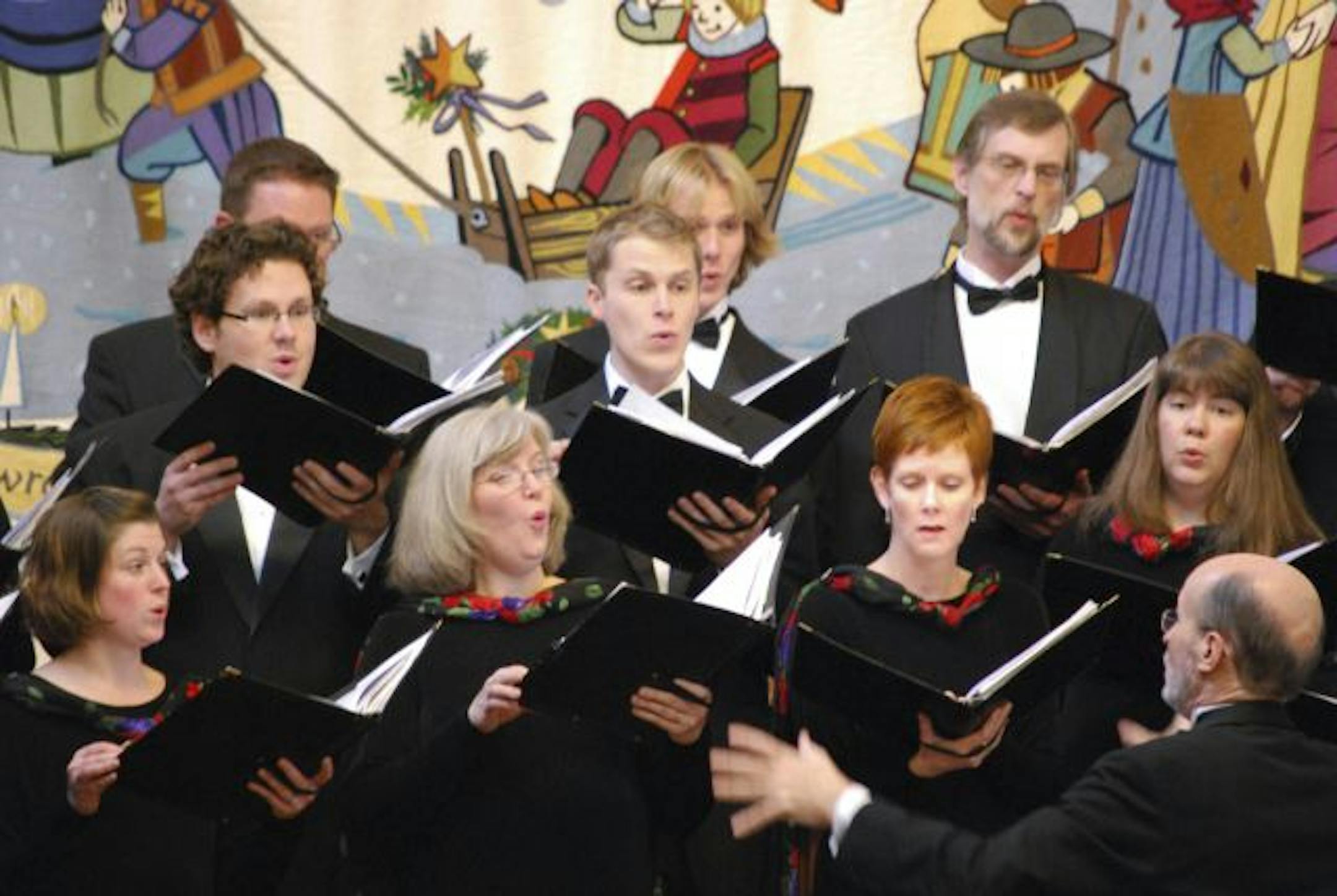 Philip Brunelle conducts the VocalEssence Ensemble Singers in a Christmas concert.