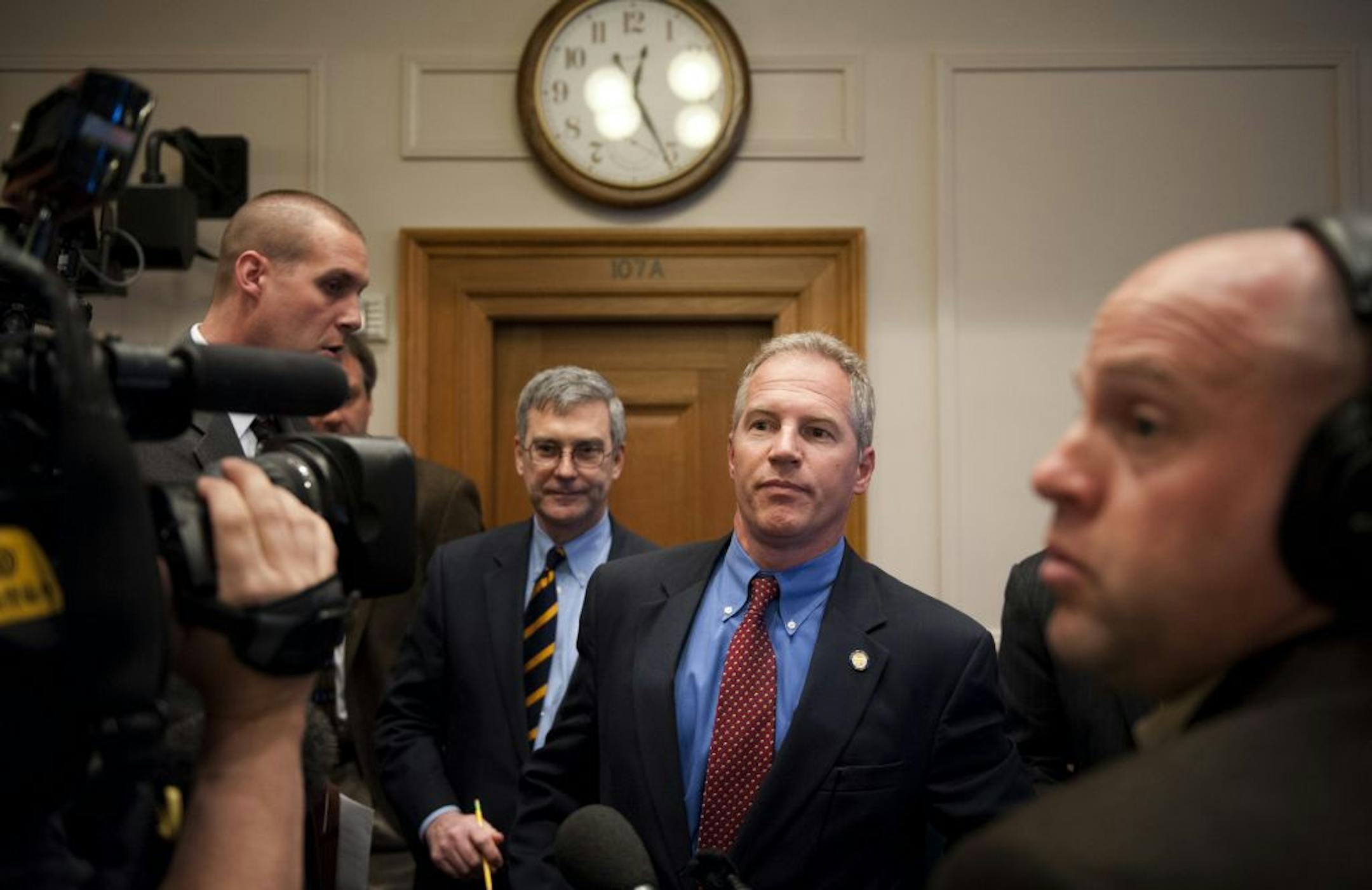 State Sen. Geoff Michel, center, spoke briefly after Tuesday's Ethics Committee hearing, calling on the members to dismiss the complaint against him: "It's not about ethics, it's about politics."