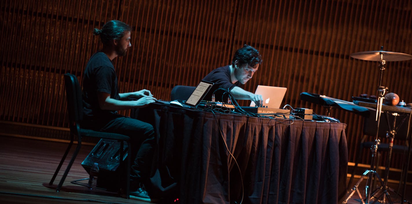 Composer Daniel Wohl (seated at right) and visual artist Daniel Schwarz deployed sounds and images from their laptops during Thursday night's concert. (Jayme Halbritter Photography)