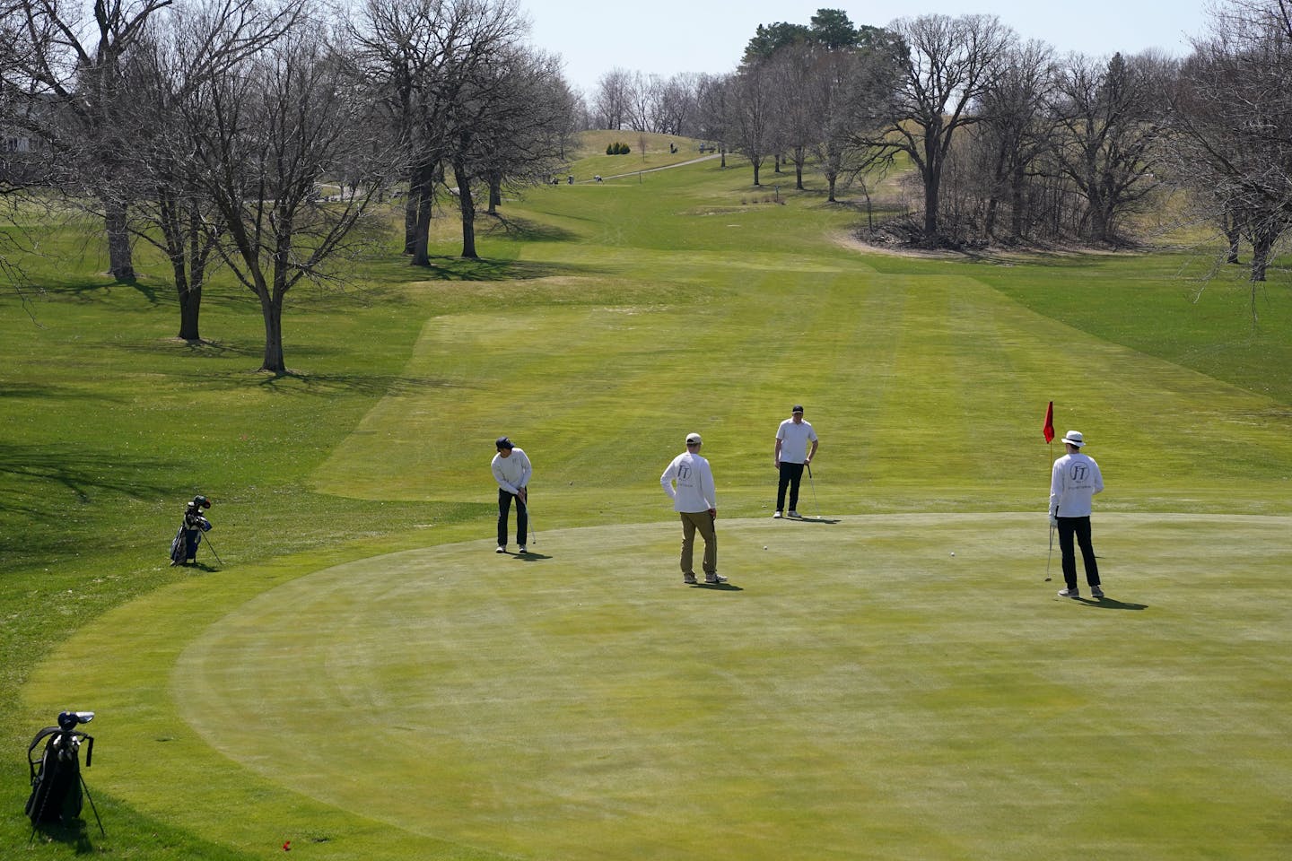 Golfers kept more than the recommended social distance from one another as they putted on the first hole Saturday at Columbia Golf Club.