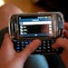 FILE -- A teenager composes a text message on her cell phone in Canton, Mass., in this May 7, 2010 file photo. One in three teenagers sends more than 