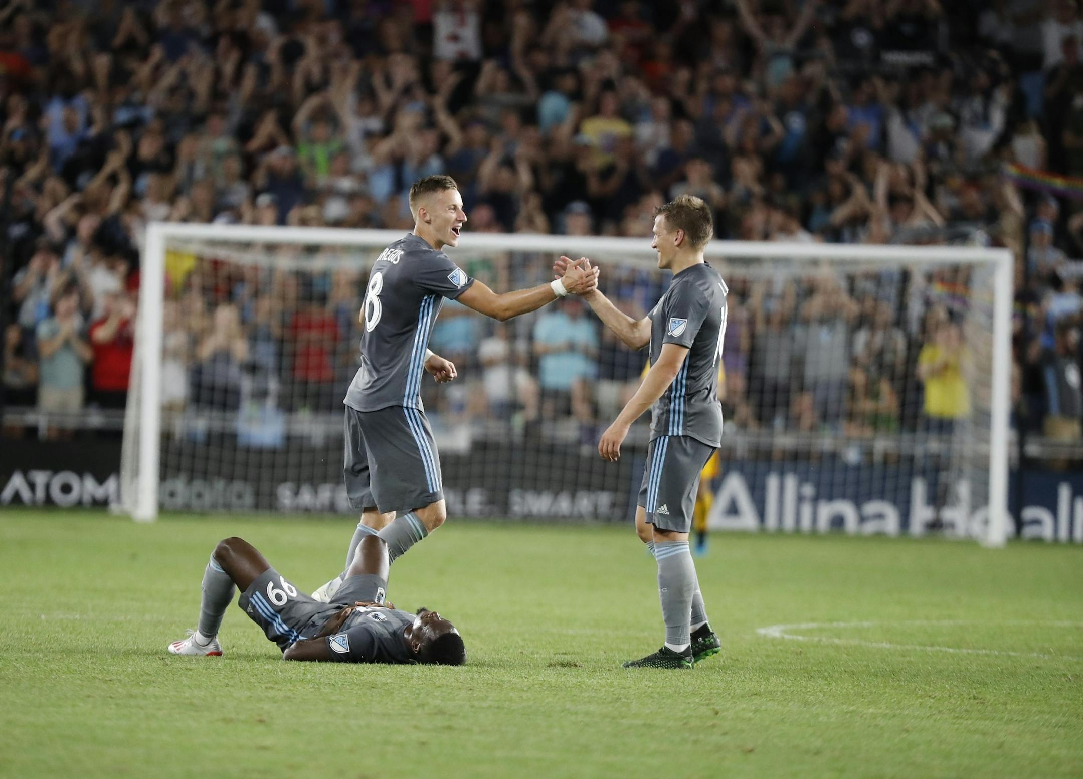 Minnesota United midfielder Jan Gregus (8), left, and Minnesota United midfielder Robin Lod (16) celebrated their win.