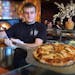 Line cook John Gustafson worked the pizza oven during a typically busy lunch hour.