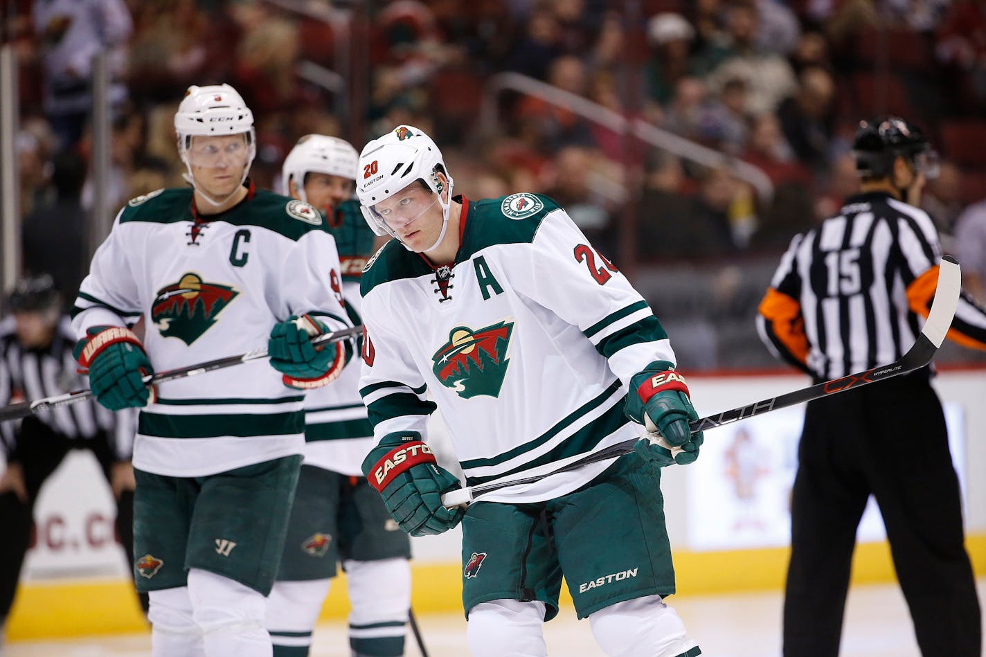 Minnesota Wild's Ryan Suter (20) and Mikko Koivu (9), of Finland, skate into position prior to a face off during the second period of an NHL hockey game Friday, Dec. 11, 2015 in Glendale, Ariz. The Coyotes defeated the Wild in overtime 2-1. (AP Photo/Ross D. Franklin)