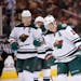 Minnesota Wild's Ryan Suter (20) and Mikko Koivu (9), of Finland, skate into position prior to a face off during the second period of an NHL hockey ga