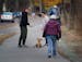 Cory Wynn, left, and his wife Maggie Wynn of Minneapolis were enjoying a walk with their golden retriever puppy Rosie when fellow walker Barb Snobeck 