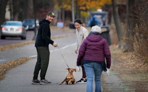 Cory Wynn, left, and his wife Maggie Wynn of Minneapolis were enjoying a walk with their golden retriever puppy Rosie when fellow walker Barb Snobeck