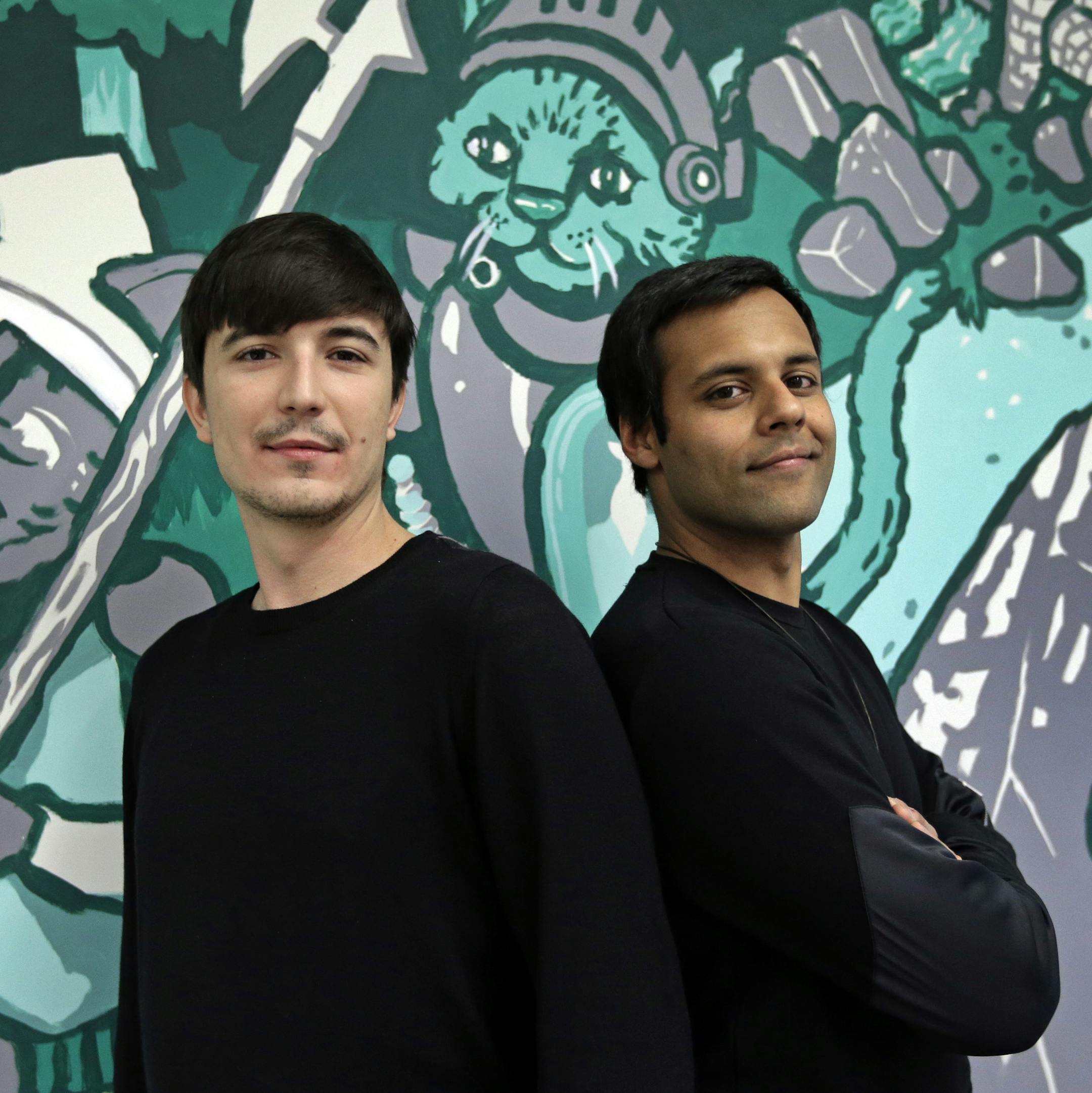 In this Wednesday, Dec. 2, 2015, photo, Robinhood co-founders Vlad Tenev, left, and Baiju Bhatt pose at company headquarters in Palo Alto, Calif. Robinhood is a stock brokerage that does not charge any commissions for its more than 1 million customers to buy and sell shares. "During the next 10 years, we are going to create an international company that will be like nothing the financial services industry has ever seen," says Bhatt. (AP Photo/Ben Margot) ORG XMIT: CABM204