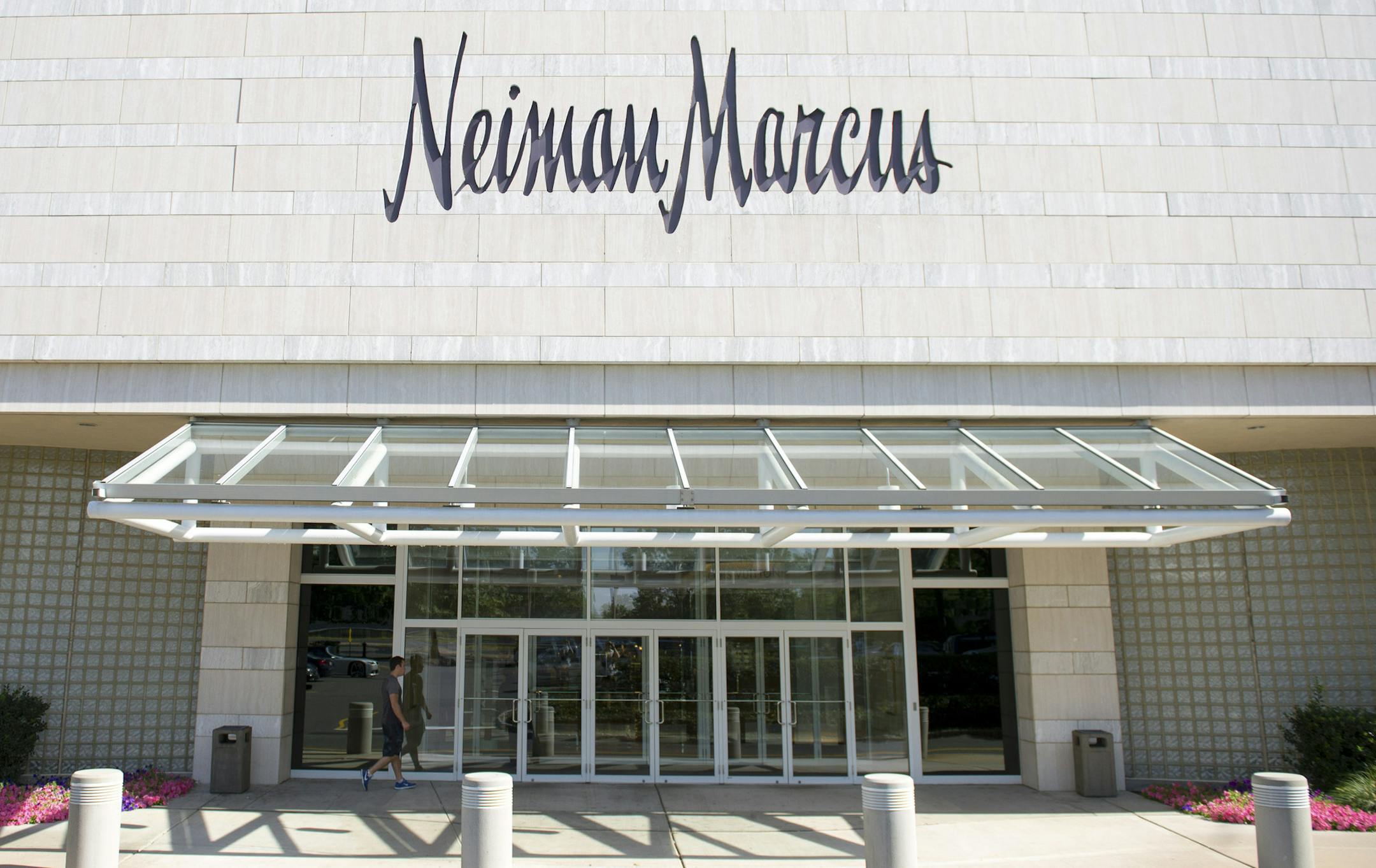 A man walks toward the entrance of a Neiman Marcus Inc. department store at the Mall at Short Hills in Short Hills, New Jersey, U.S., on Monday, Sept. 9, 2013. Neiman Marcus Inc., the Dallas-based luxury chain, agreed to sell itself to Ares Management LLC and the Canada Pension Plan Investment Board for $6 billion. Photographer: Craig Warga/Bloomberg ORG XMIT: 180262449