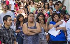 FILE - In this Aug. 15, 2012, file photo, a line of people living in the U.S. without legal permission wait outside the Coalition for Humane Immigrant