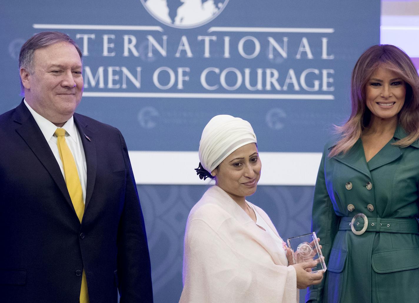 Razia Sultana of Bangladesh poses with Secretary of State Mike Pompeo and first lady Melania Trump as she is awarded the 2019 International Women of Courage at the Department of State in Washington, Thursday, March 7, 2019. (AP Photo/Andrew Harnik)