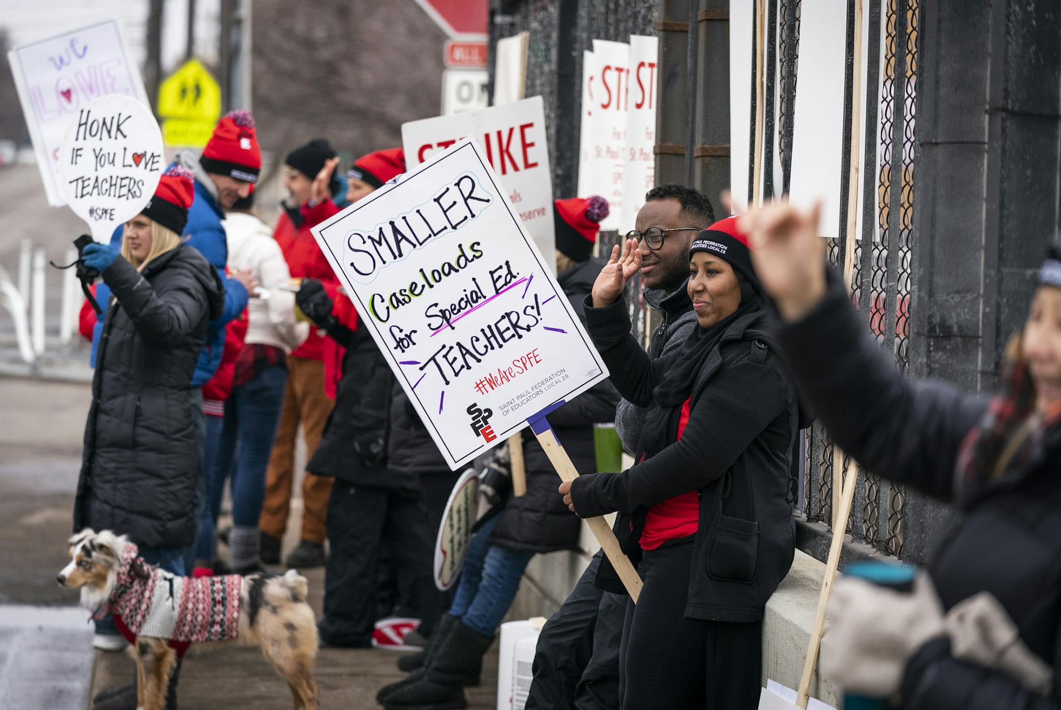 Khadija Abukar, center holding sign, a special education teacher at Maxfield Elementary School, waved to passing cars on Victoria Street bridge over I-94 during the strike. ] LEILA NAVIDI • leila.navidi@startribune.com BACKGROUND INFORMATION: St. Paul teachers and educators from Maxfield Elementary School picket on the Victoria Street bridge over I-94 in St. Paul on Wednesday, March 11, 2020. Day two of the St. Paul teachers and educators strike.