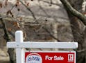 FILE - In this Jan. 3, 2019, file photo a realtor sign marks a home for sale in Franklin Park, Pa. The partial federal government shutdown is complica